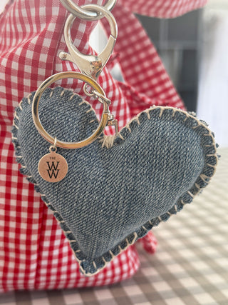 Recycled denim keyring with hand-stitched edge on ruffle handbag – sustainable style