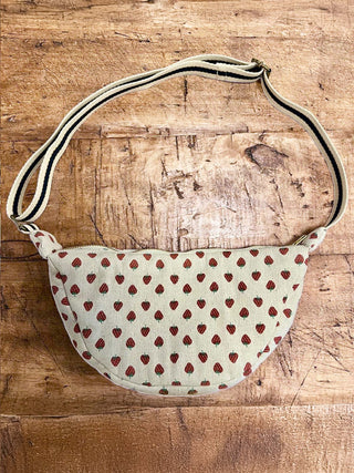 Fabric bag with strawberry pattern on a wooden surface