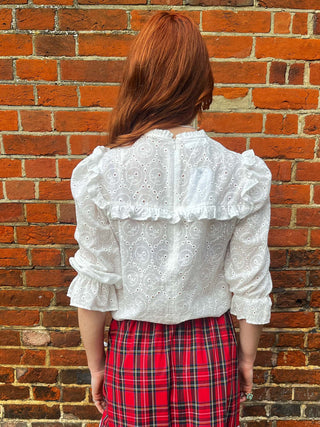 women wearing pretty top and tartan skirt back