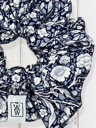 Navy floral patterned fabric with a visible brand label on a white background