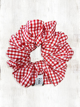 Red and white checkered scrunchie on a light wooden surface