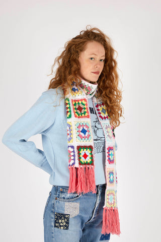 model-looking-camera-wearing-crochet-scarf