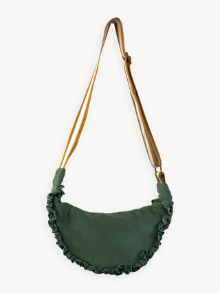 Green shoulder bag with ruffled details and a brown strap on a white background