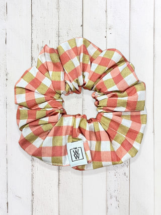Plaid headband with visible brand logo on a wooden background