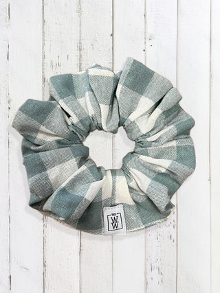 Plaid scrunchie on a white wooden background