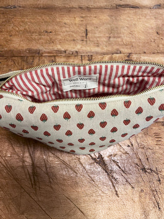 Fabric bag with strawberry pattern on a wooden surface