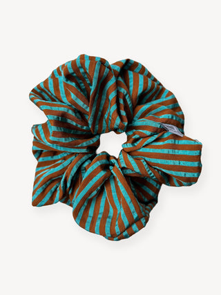 Striped scrunchie with brown and blue pattern on a white background