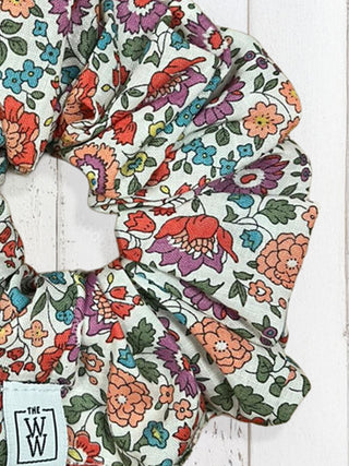 Floral patterned fabric with visible brand logo on a white background