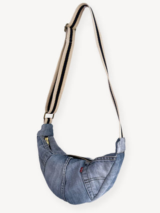 vintage denim bag with a strap on a white background