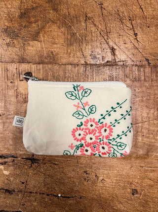 Small pouch with floral design on a wooden surface
