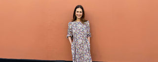 Model wearing The Well Worn Floral Cotton Sustainable Midi Dress, showcasing its flattering fit and vibrant floral pattern