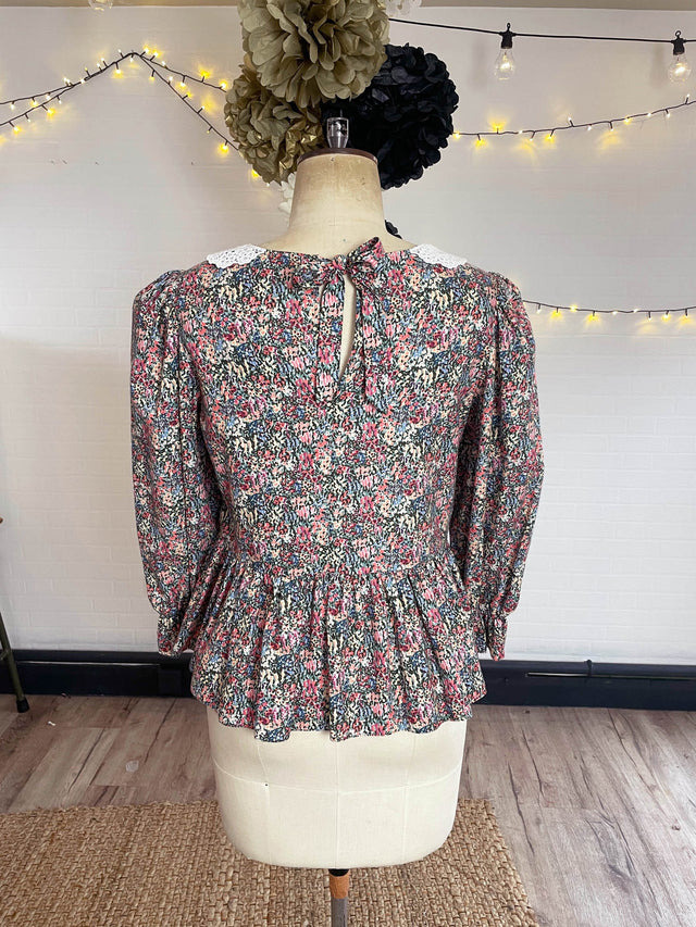 The Well Worn floral top bacl view on mannequin