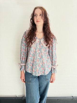 Model wearing Luna Floral Print Blouse made from deadstock fabric in pink and blue tones