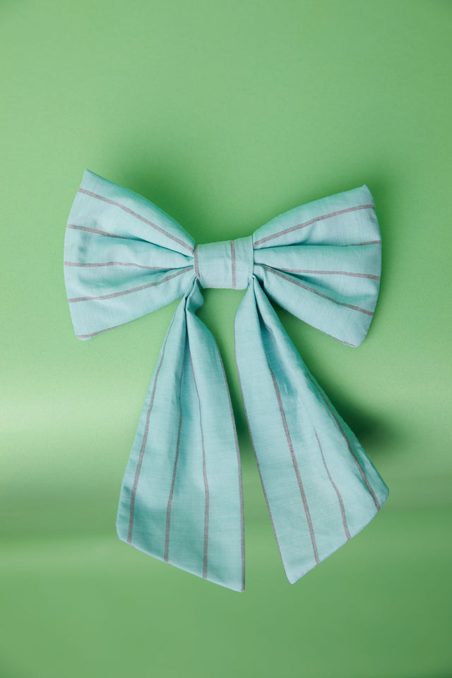 The Well Worn turquoise blue bow on table