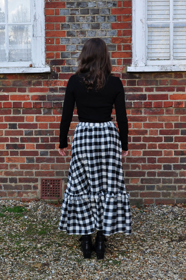 The Well Worn woman wearing gingham skirt back