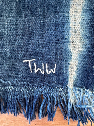 Blue fabric with 'TWW' embroidered on it