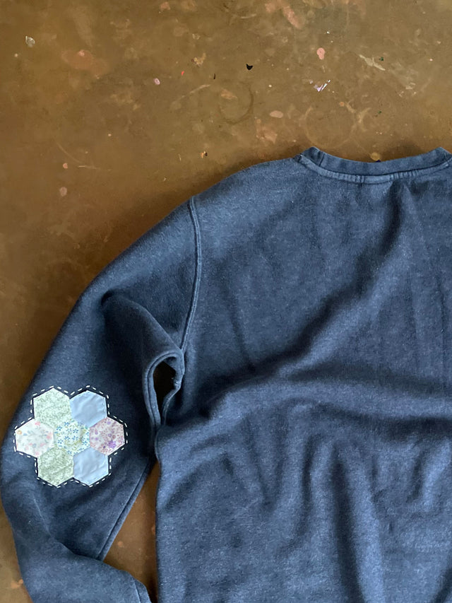 reworked sweatshirt on table detail