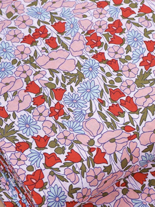 Floral patterned fabric with red, pink, and blue flowers on a light background