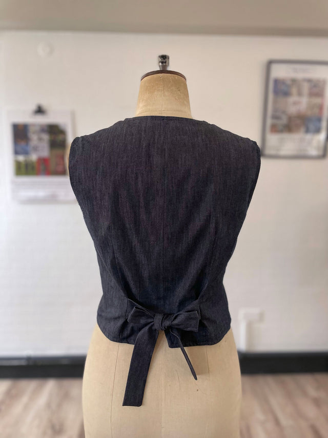 The Well Worn denim waistcoat on mannequin bow back