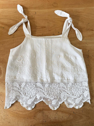 White lace-trimmed top on a wooden surface