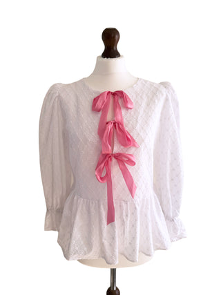 Front view of The Bethany Top in white broderie anglaise cotton with pink satin bow ties