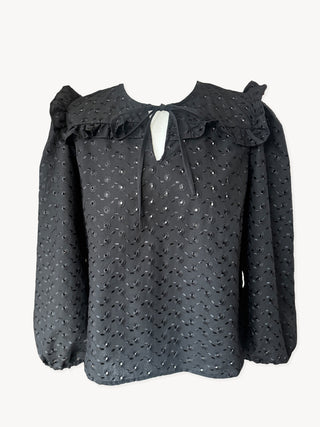 Black blouse with ruffled collar on a white background