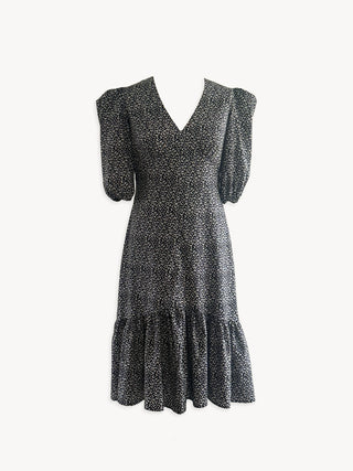 Black and white floral cotton midi dress with V neckline, puff sleeves, drop-hem skirt, and concealed zip, ethically made in the UK.