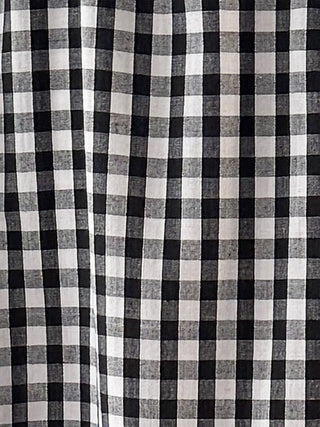 The Romana Gingham Tiered Skirt in black & white check with ruffled tiers, side pockets, and midi-to-maxi length.