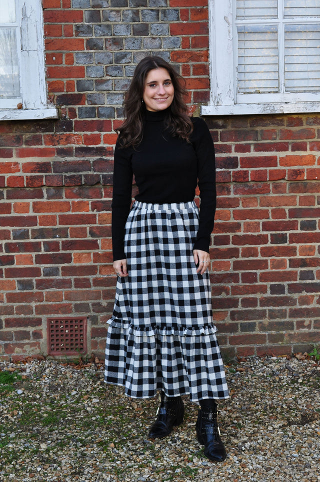 The Well Worn woman wearing gingham skirt