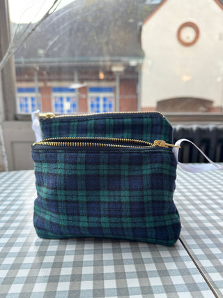 Plaid pouch with gold zipper on a checkered tablecloth