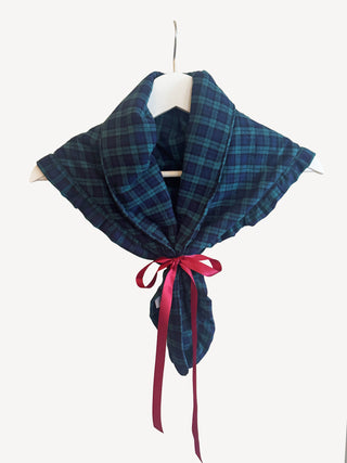 Blue plaid scarf with a pink ribbon on a white background