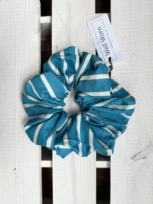 The Well Worn blue stripe scrunchie on wooden table