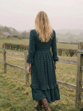 back model wearing tartan dress in countryside