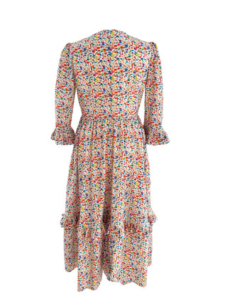The Felicity Midi Dress in Rainbow Meadow print, made from sustainable cotton with a fitted bodice, full skirt, and stylish ruffled cuffs.