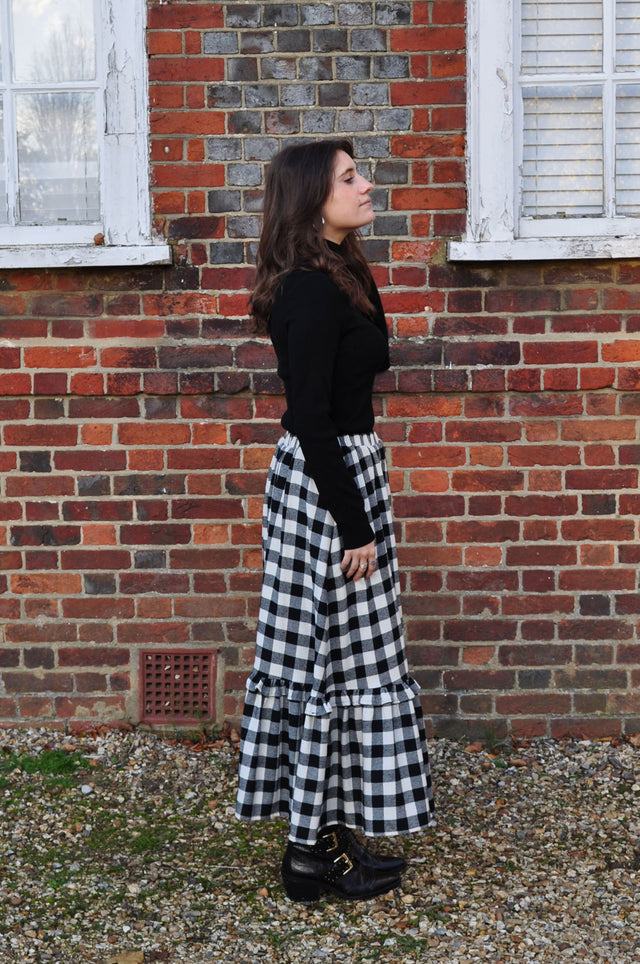 The Well Worn woman wearing gingham skirt side