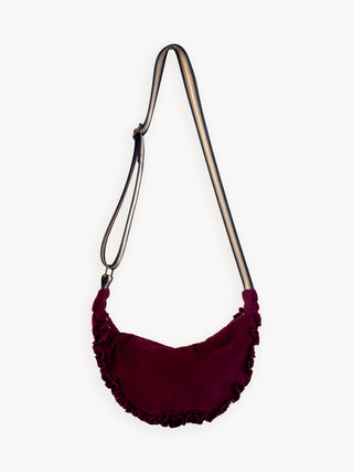 Burgundy ruffled bag with a metal handle on a white background