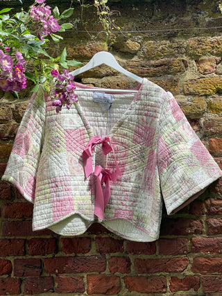 pink quilted jacket on wall