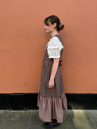 women wearing checked waistcoat side view