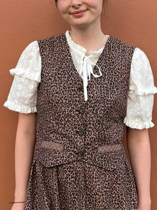 women wearing checked waistcoat and skirt