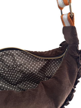 Brown bag with polka dot interior on a white background