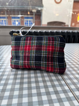 Plaid pouch on a checkered tablecloth with a blurred indoor background