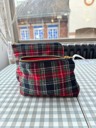 Plaid pouches on a checkered tablecloth with a window in the background