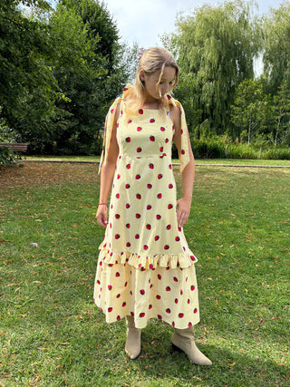 The Mila Dress photographed in natural light – ethical fashion piece in deadstock strawberry stripe cotton, designed for seasonal styling
