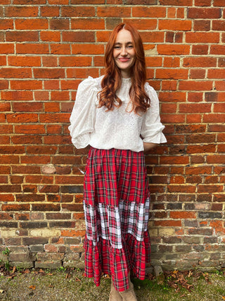 women wearing pretty top and tartan skirt