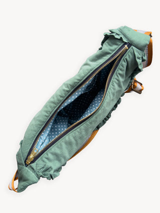 Green bag with open zipper on a white background