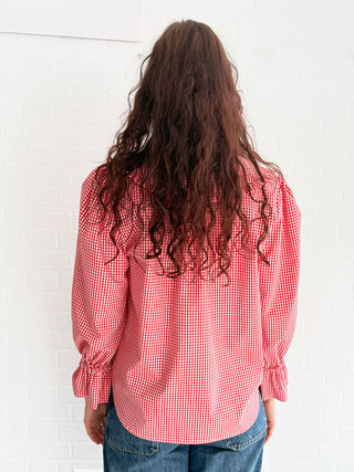 Slow fashion in action – model wearing structured red gingham blouse with full sleeves