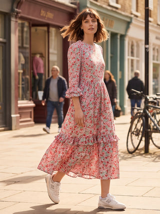 Woman in a floral dress walking on a city street
