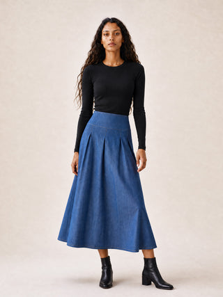 women wearing denim skirt with black top
