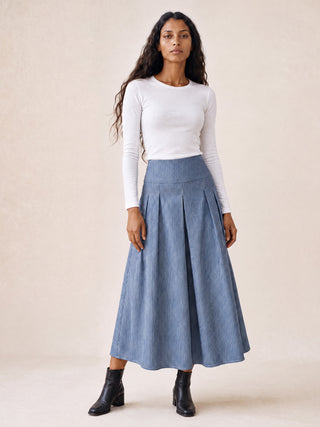 women wearing stripe skirt and white top
