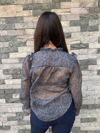 back of women wearing tie front ruffle blouse
